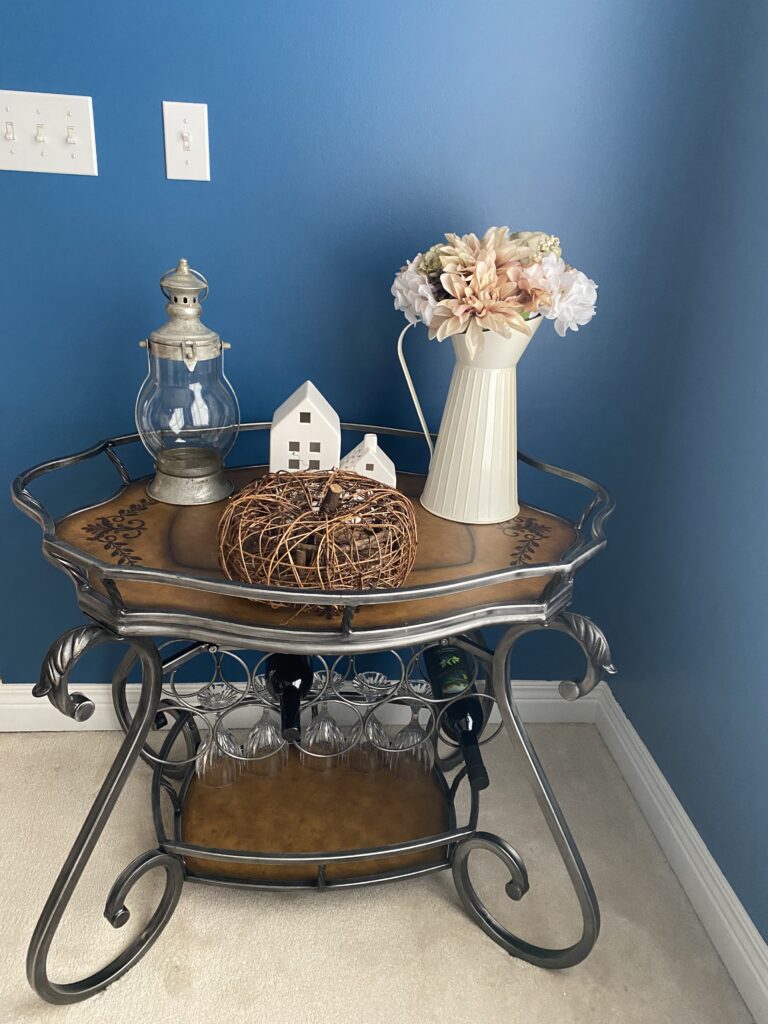 Wine rack, bar cart, dining room furniture.